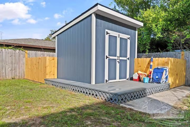 view of shed featuring fence