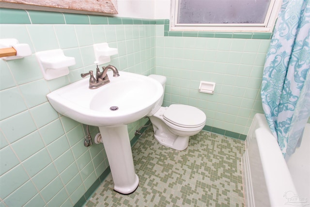 bathroom with tile patterned floors, toilet, tile walls, and shower / bath combination with curtain