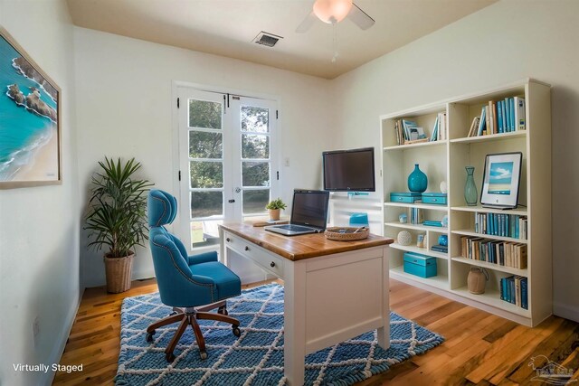 office featuring wood finished floors, baseboards, visible vents, ceiling fan, and french doors