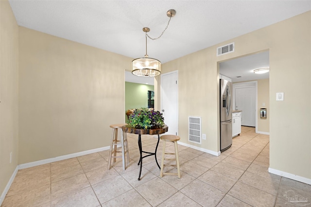 dining area with baseboards, visible vents, and light tile patterned flooring
