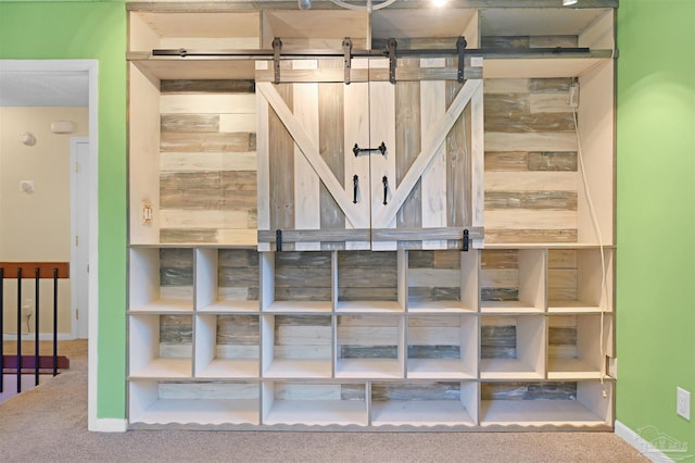 interior space featuring baseboards and carpet