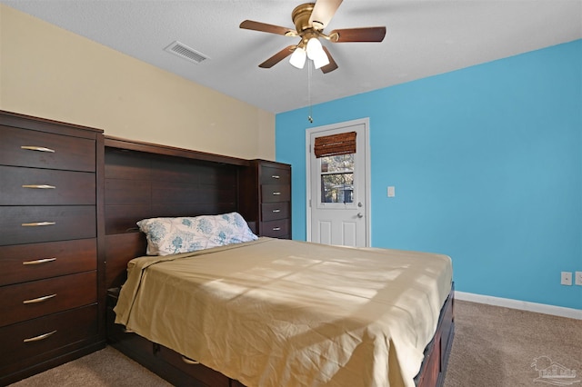 carpeted bedroom with baseboards, visible vents, and ceiling fan