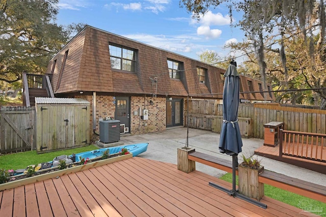 deck with a patio, a fenced backyard, a gate, and central AC unit
