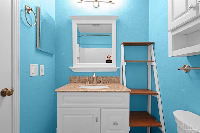 full bathroom featuring toilet and vanity