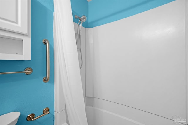 bathroom with toilet and shower / bath combination with curtain