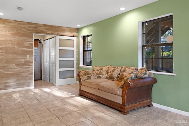 living area with tile patterned flooring, visible vents, recessed lighting, and a healthy amount of sunlight