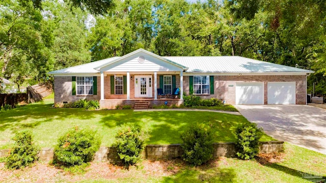 ranch-style house featuring a porch, a garage, and a front yard