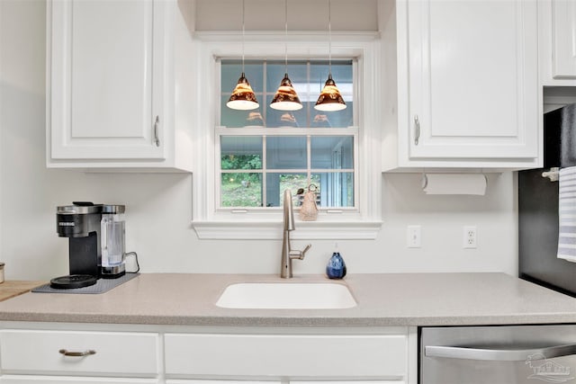 kitchen featuring white cabinets, dishwasher, and sink