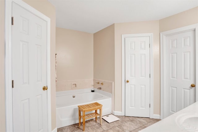 bathroom featuring tile patterned flooring, vanity, and a bathtub