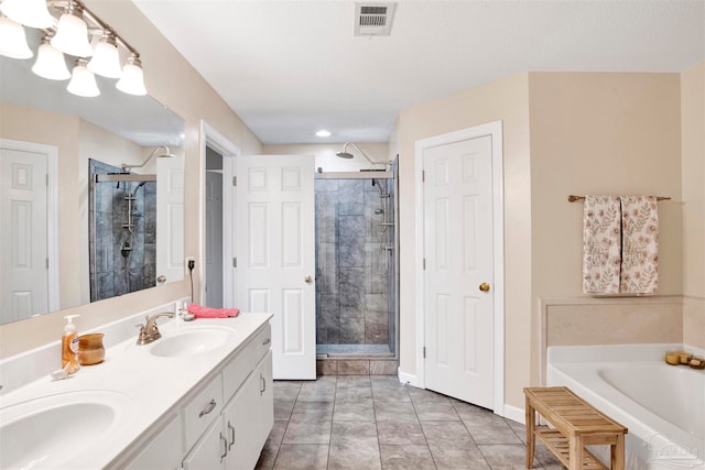 bathroom featuring tile patterned flooring, shower with separate bathtub, and double sink vanity