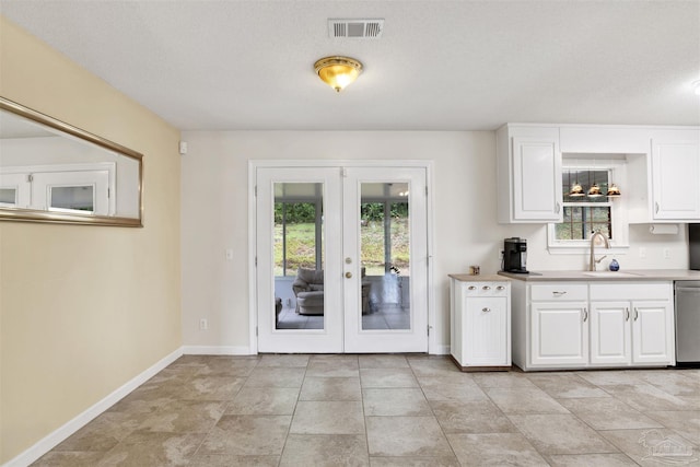 kitchen featuring sink, light tile patterned floors, and plenty of natural light