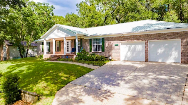 view of front of house with a garage and a front yard