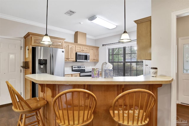 kitchen with pendant lighting, dark wood-type flooring, stainless steel appliances, ornamental molding, and kitchen peninsula