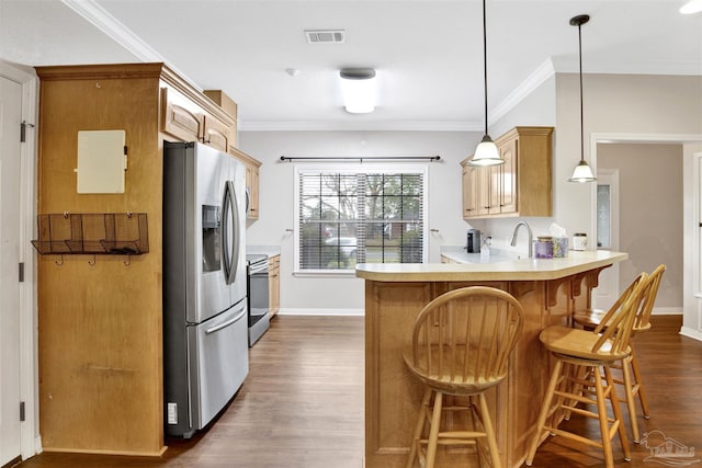 kitchen featuring dark wood-type flooring, decorative light fixtures, ornamental molding, kitchen peninsula, and stainless steel appliances