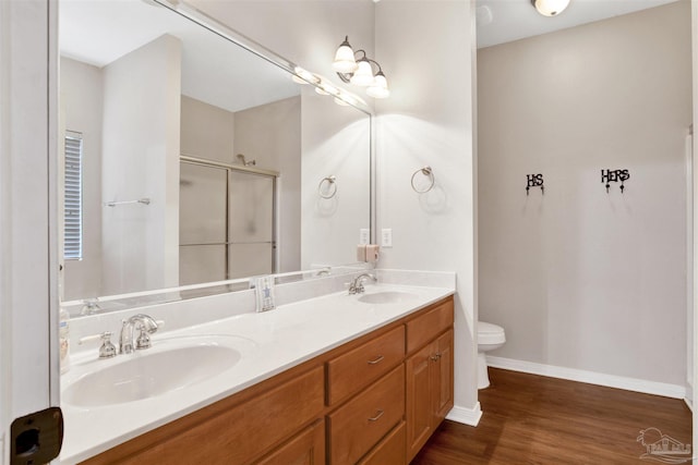 bathroom with vanity, hardwood / wood-style floors, toilet, and walk in shower