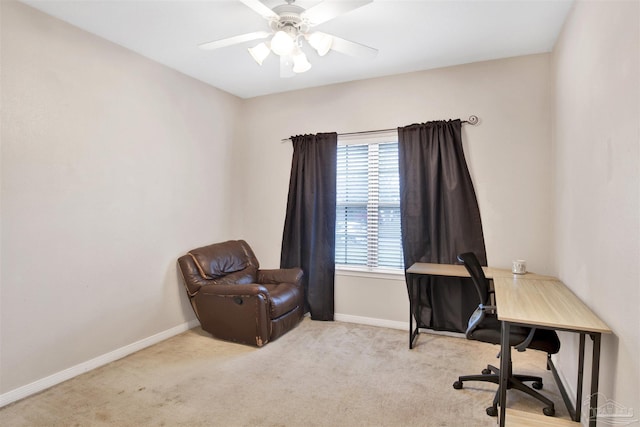 carpeted office space featuring ceiling fan