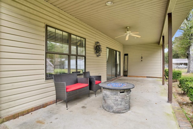 view of patio / terrace featuring ceiling fan and a fire pit