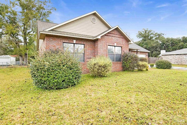 rear view of property featuring a yard