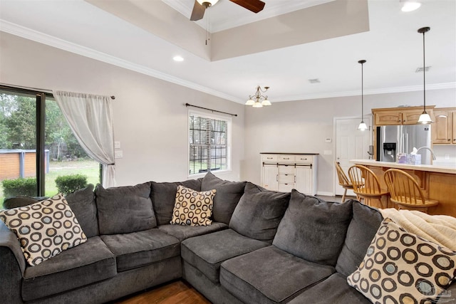 living room with crown molding, sink, hardwood / wood-style floors, and ceiling fan