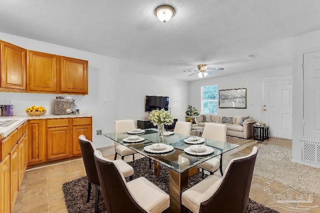 dining room with ceiling fan and light tile patterned flooring