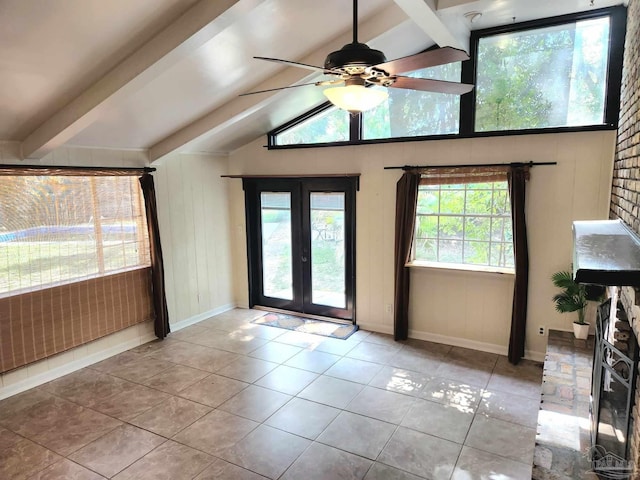 interior space featuring vaulted ceiling with beams, a healthy amount of sunlight, and light tile patterned floors