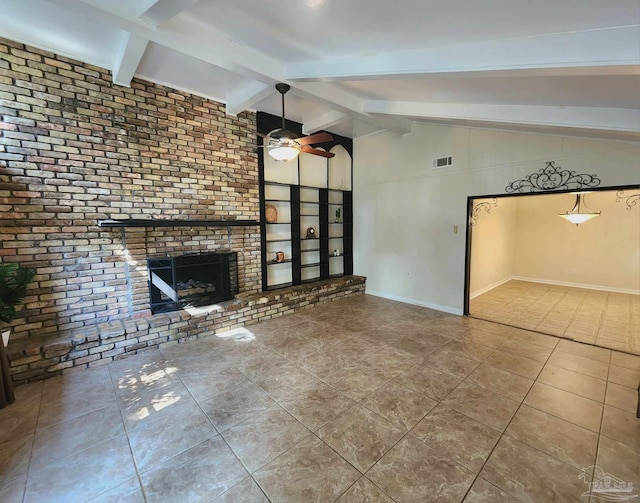 unfurnished living room featuring built in shelves, lofted ceiling with beams, a fireplace, and tile patterned floors