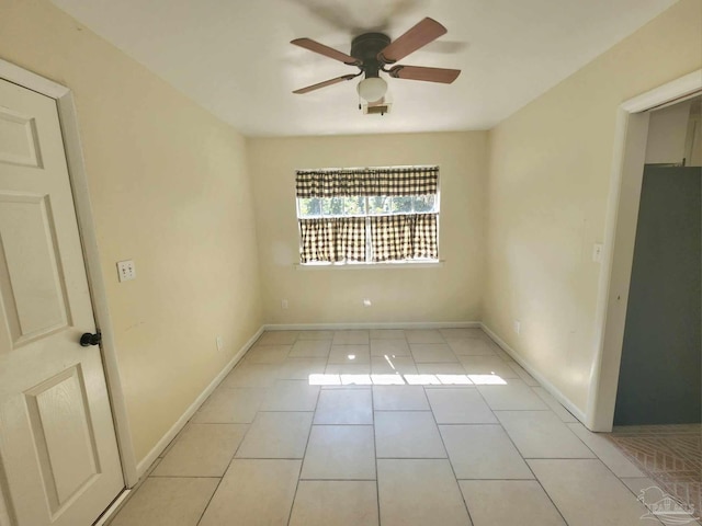 unfurnished bedroom with fridge, ceiling fan, and light tile patterned floors