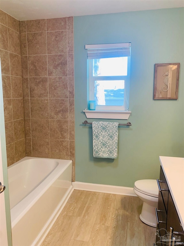 bathroom featuring vanity, hardwood / wood-style flooring, and toilet