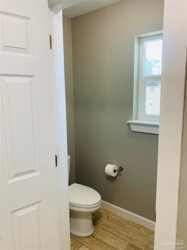 bathroom with toilet and hardwood / wood-style floors