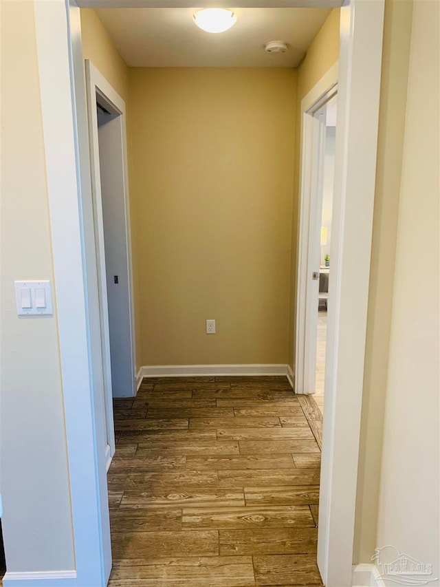 hall with hardwood / wood-style floors