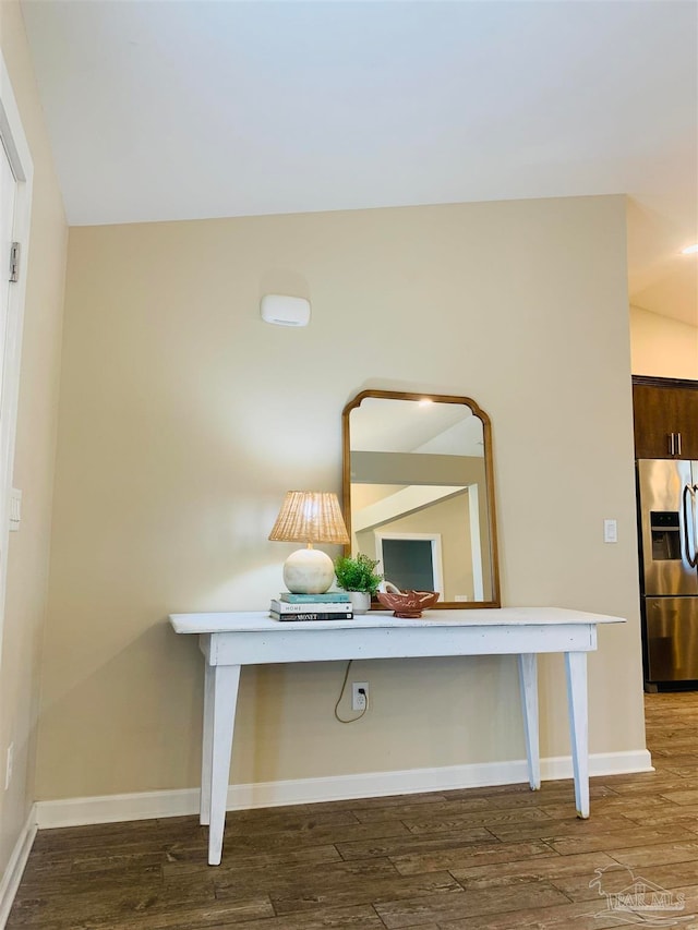 room details with hardwood / wood-style floors and stainless steel fridge with ice dispenser