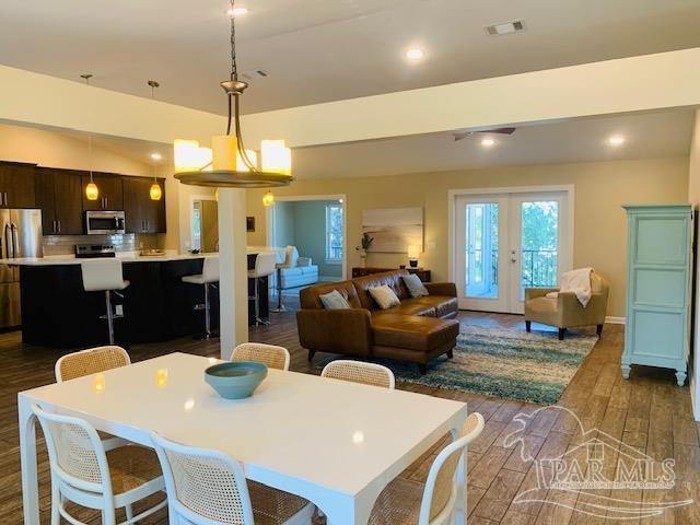 dining room with dark hardwood / wood-style floors and french doors