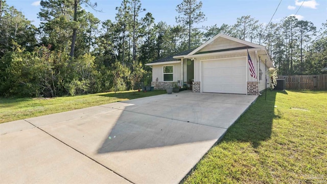 view of front of property featuring brick siding, central air condition unit, a front yard, a garage, and driveway