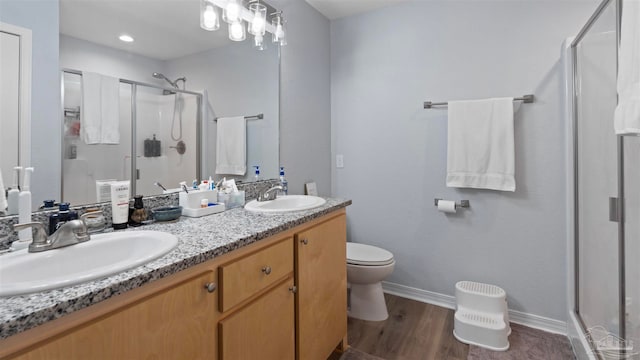 full bath featuring a stall shower, a sink, and double vanity