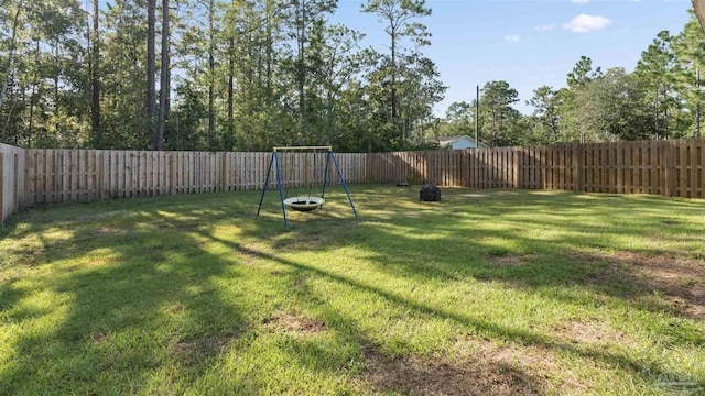 view of yard featuring a fenced backyard and a playground