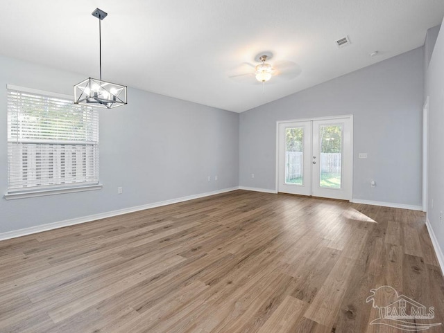 unfurnished room featuring a healthy amount of sunlight, visible vents, french doors, and lofted ceiling