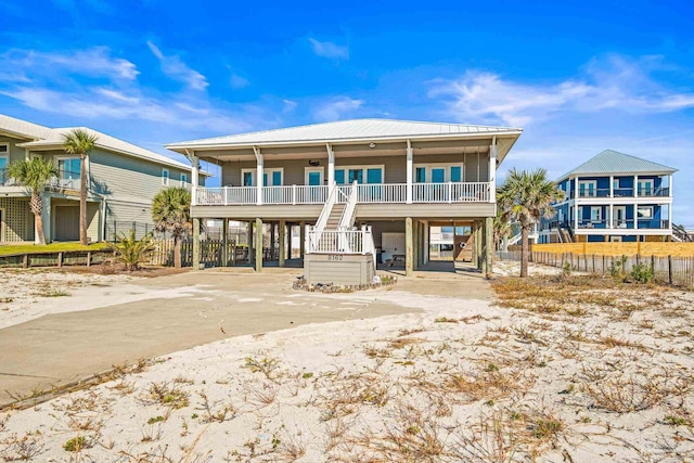 coastal inspired home featuring a carport and a porch