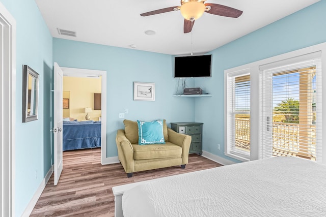 bedroom featuring access to exterior, wood-type flooring, and ceiling fan