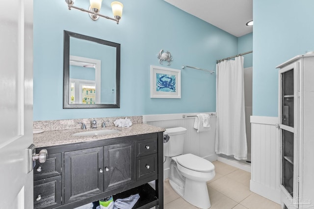 bathroom featuring vanity, a shower with curtain, toilet, and tile patterned floors