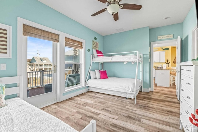 bedroom featuring ceiling fan, light hardwood / wood-style floors, and access to exterior