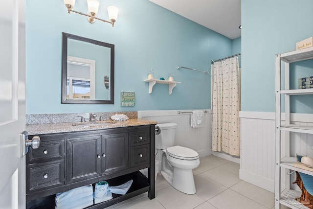 bathroom featuring toilet, vanity, and tile patterned floors