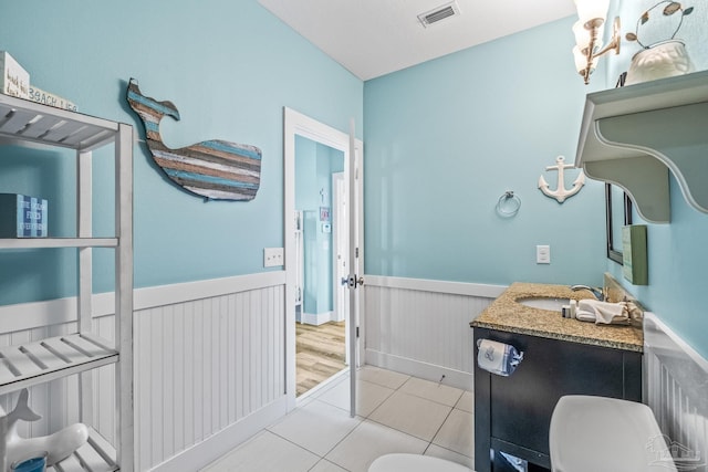 bathroom featuring vanity, toilet, and tile patterned floors