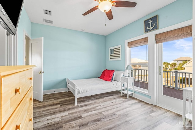 bedroom featuring access to exterior, light wood-type flooring, and ceiling fan