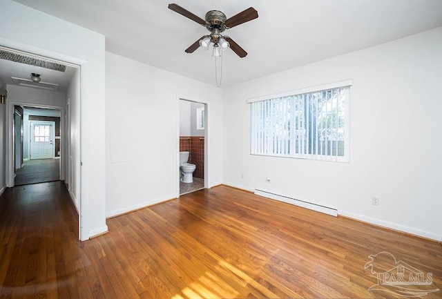 unfurnished room featuring a baseboard heating unit, wood-type flooring, and ceiling fan