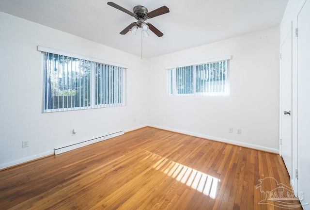 unfurnished room with ceiling fan, wood-type flooring, and a baseboard heating unit