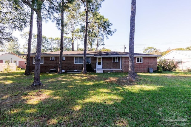 rear view of property featuring a yard