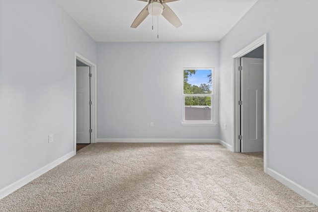 carpeted empty room featuring ceiling fan