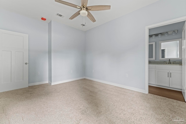 spare room featuring carpet flooring, ceiling fan, and sink