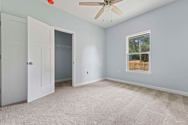 unfurnished bedroom with ceiling fan, a closet, and light colored carpet