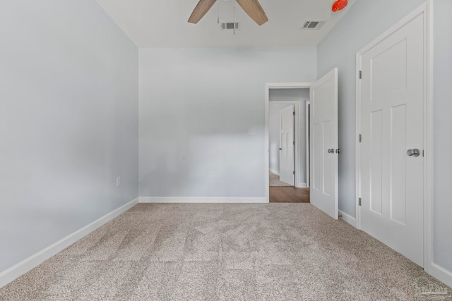 carpeted spare room with ceiling fan